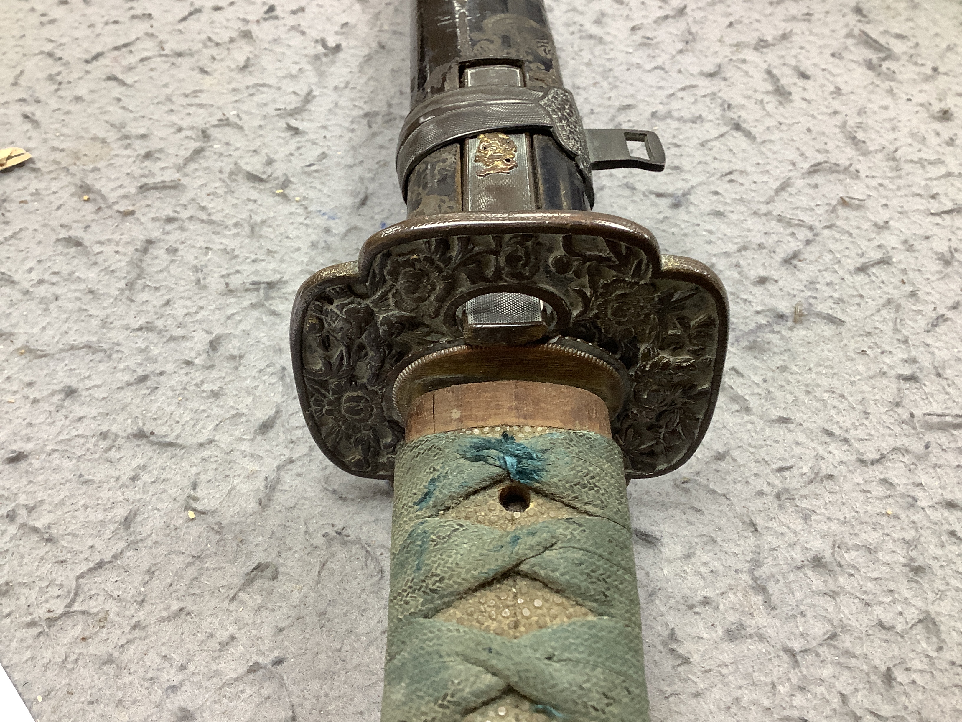 A 19th century Japanese katana with signature to the tang, with chiselled bronze tsuba and gilt metal menuki, and six various knives, blade 57cm